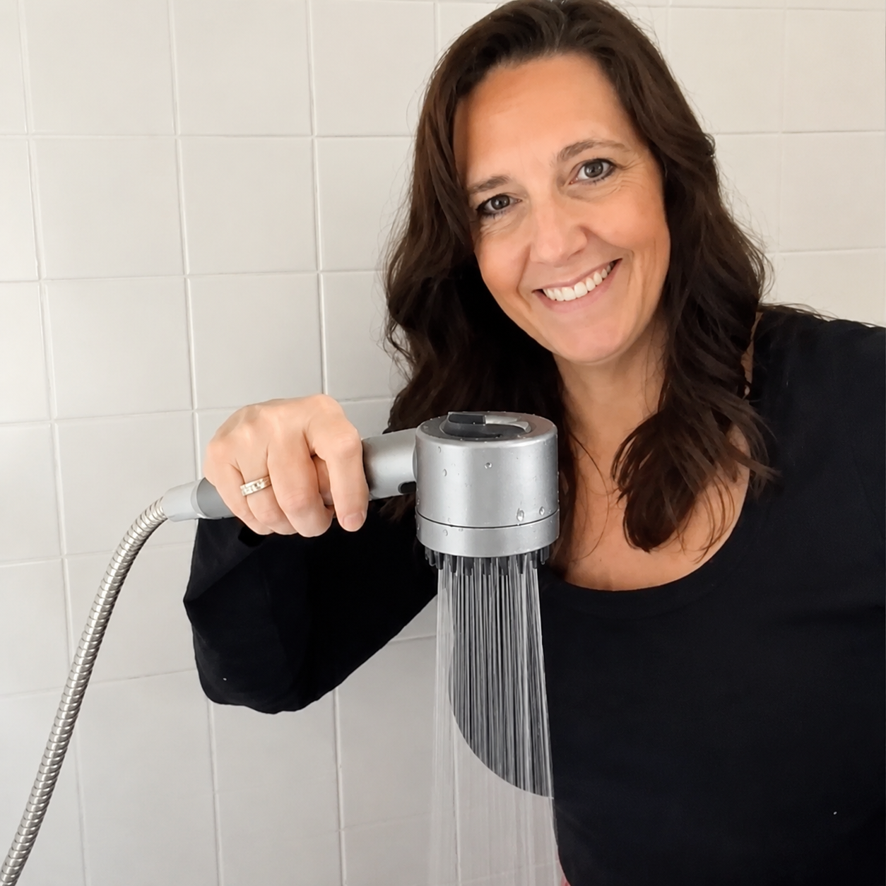 IonDrops shower head installed and running in a modern bathroom